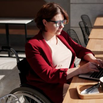 woman in red blazer sitting on wheelchair